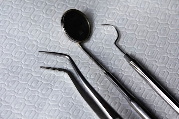 Dental mirror and explorer laid out on a sterile tray