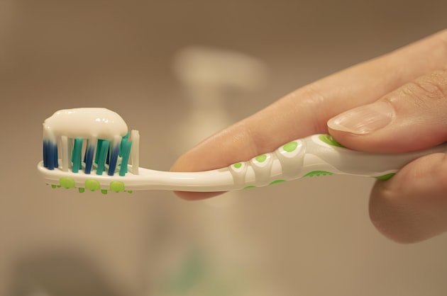 Toothbrush with a strip of toothpaste