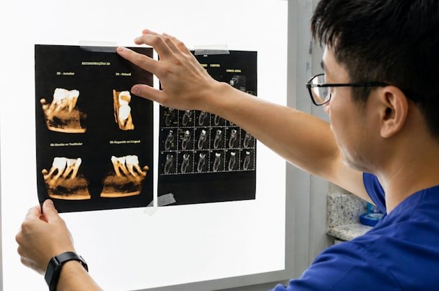 Clinician reviewing dental radiographs on a light box